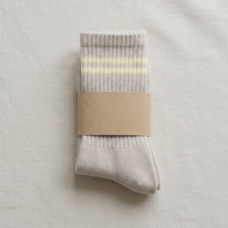 STROMA socks in a plain unbleached kraft belly band — zero plastic packaging