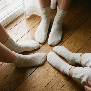Family feet together in undyed Unit 02 socks